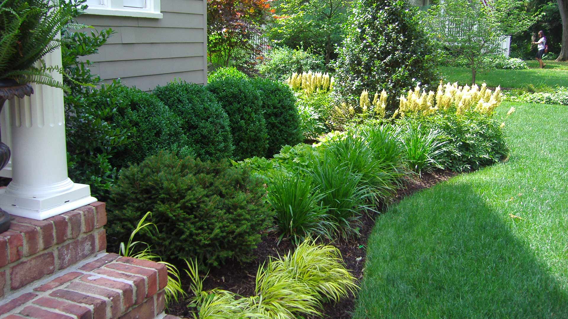 Beautiful lawn and landscape with healthy green grass and colorful shrubs in Bridgewater, NJ.