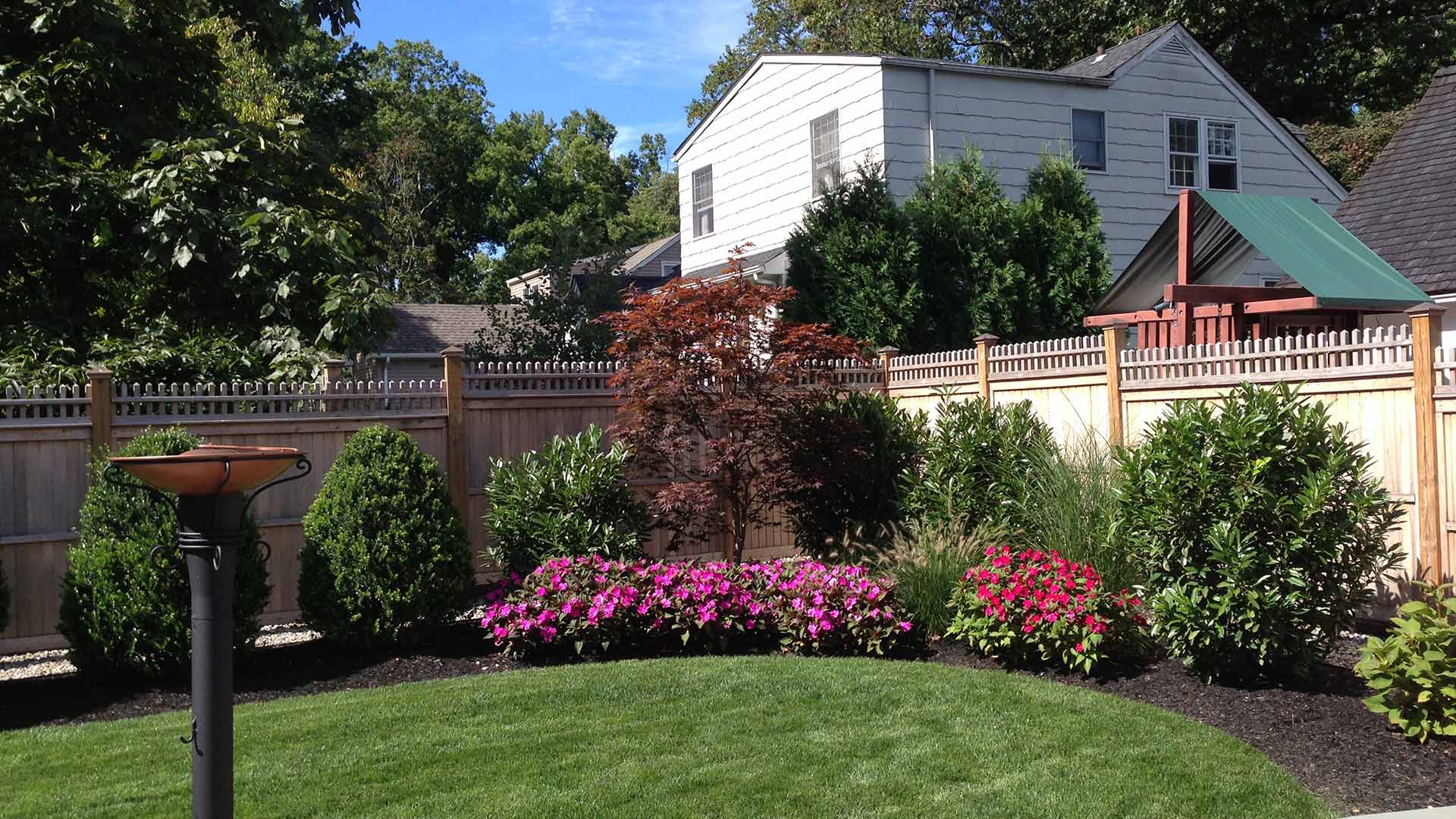 Well trimmed and properly landscaped home back yard in Plainfield, NJ.